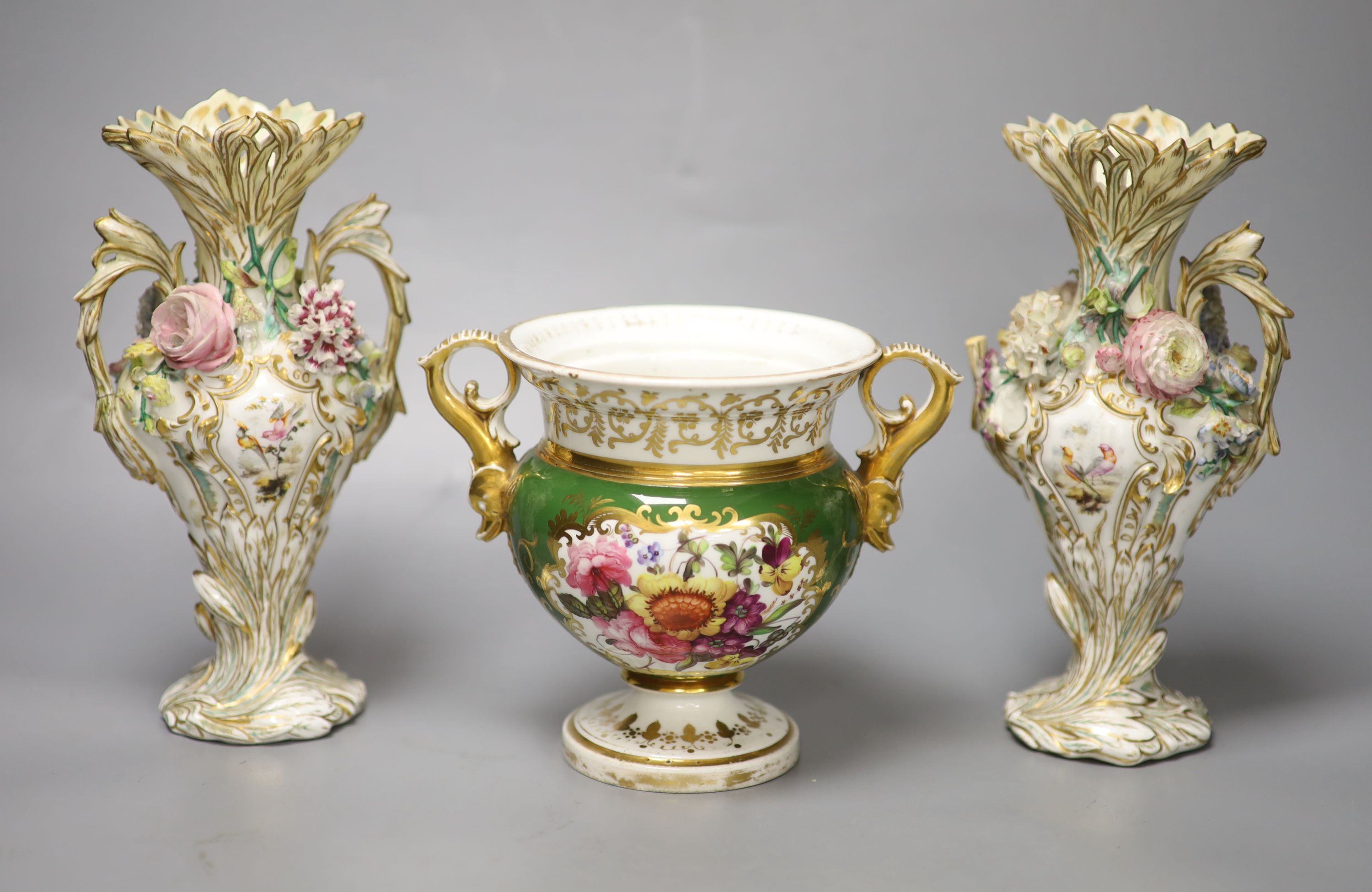 An English porcelain two handled green ground vase and a pair of floral encrusted vases, 20cm